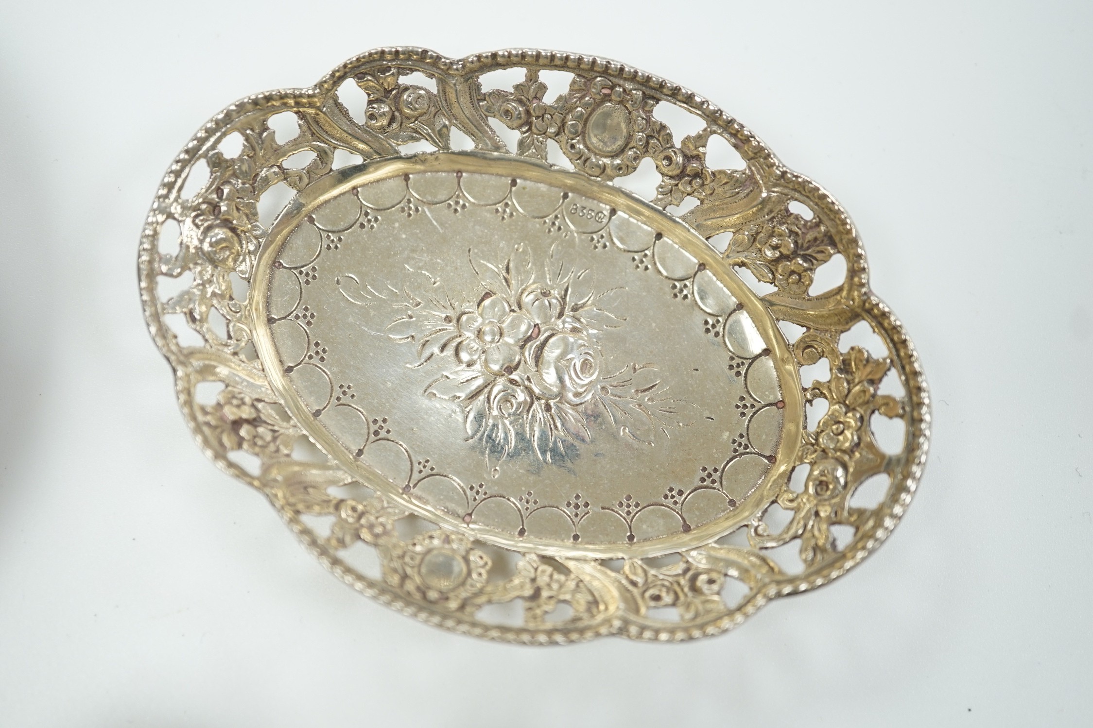 A modern silver mounted bottle coaster and two continental white metal small dishes.
